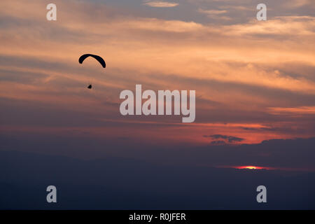 Silhouette of a para-glider against a beautiful sky Stock Photo