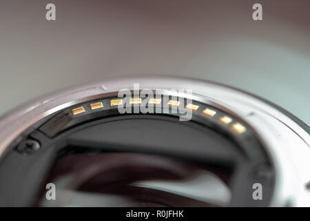Gold contacts on the back of a camera lens Stock Photo