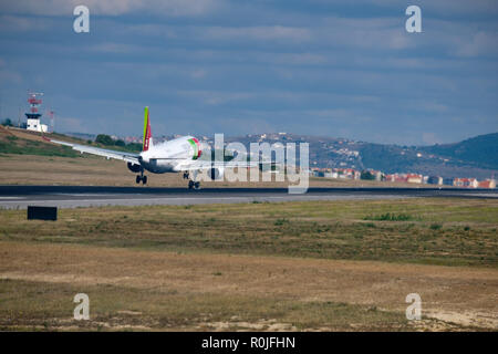 TAP airplane touching ground during landing at Humberto Delgado Airport in Lisbon, Portugal, Europe Stock Photo