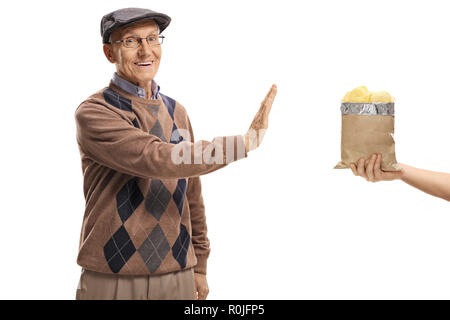 Elderly man refusing a bag of chips isolated on white background Stock Photo