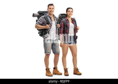 Full length portrait of male and female hikers with backpacks standing and looking at the camera isolated on white background Stock Photo