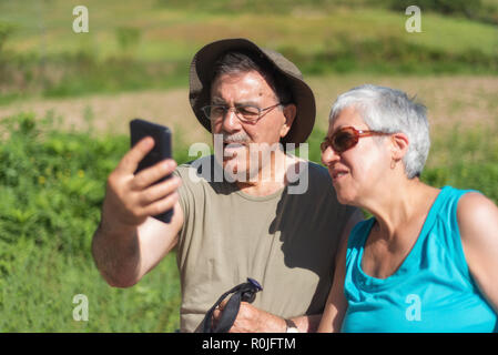 Senior couple on hike taking a selfie Stock Photo