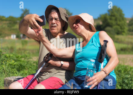 Senior couple on hike taking a selfie Stock Photo