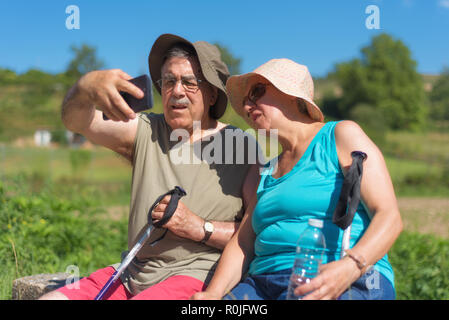 Senior couple on hike taking a selfie Stock Photo