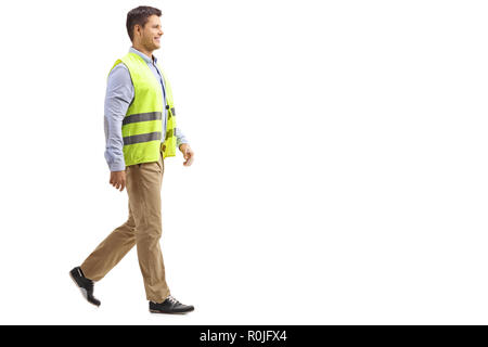 Full length shot of a smiling young man wearing safety vest and walking isolated on white background Stock Photo