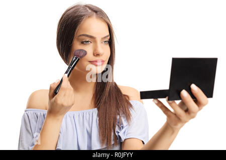 Young woman applying make-up isolated on white background Stock Photo