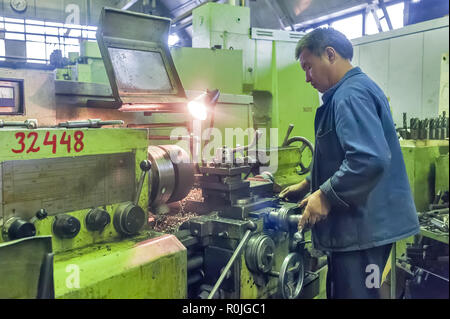 Tyumen, Russia - September 7, 2010: JSC Tyumenskie Motorostroiteli. Plant on production and repair of aviation engines. Milling-machine operator works Stock Photo
