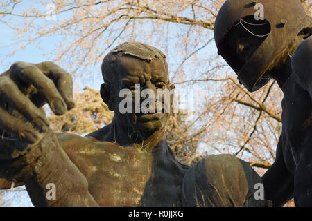 Timeline of the rising sun during the winter dusk sky viewed from behind the Bronze sculpture in the military cemetery Reimsbach an der Saar, Germany. Stock Photo