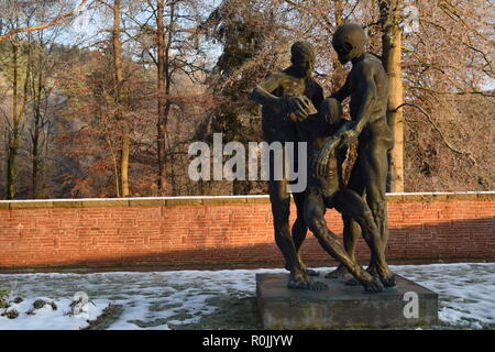 Timeline of the rising sun during the winter dusk sky viewed from behind the Bronze sculpture in the military cemetery Reimsbach an der Saar, Germany. Stock Photo