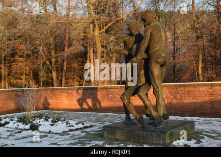 Timeline of the rising sun during the winter dusk sky viewed from behind the Bronze sculpture in the military cemetery Reimsbach an der Saar, Germany. Stock Photo