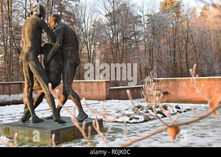 Timeline of the rising sun during the winter dusk sky viewed from behind the Bronze sculpture in the military cemetery Reimsbach an der Saar, Germany. Stock Photo