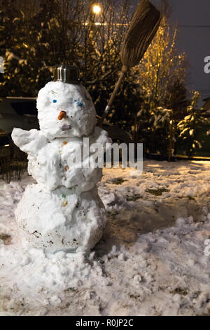 Handmande snowman at the yard with broom in his hand Stock Photo