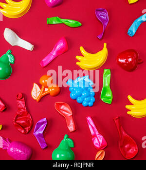 abstract background with childrens plastic toys and blown-out multi-colored balloons Stock Photo