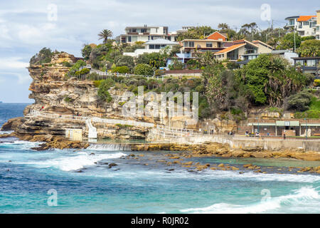 Bondi to Coogee coastal walk  southern end of Bronte Beach and dwellings on sandstone cliff over Pacific Ocean Sydney NSW Australia.