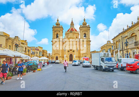 XAGHRA, MALTA - JUNE 15, 2018: The scenic Basilica of Nativity with huge dome and bell towers with clocks is the pearl of town, located on Knisja stre Stock Photo