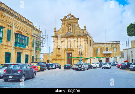 VICTORIA, MALTA - JUNE 15, 2018: The carved facade of St Francis of Assisi Cgurch with, decorated with relief garlands and statues of Saints in niches Stock Photo