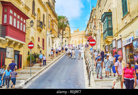 VICTORIA, MALTA - JUNE 15, 2018: The numerous tourists on the way to historic Cittadella of Rabat - the medieval fortress, located on the top of the h Stock Photo