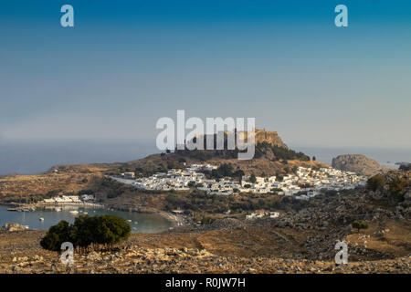 The historic town of Lindos,with its whiewashed walls and the medieaval acropolis which towers above it. Stock Photo