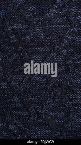 background of dark blue warm wool knitted clothes Stock Photo