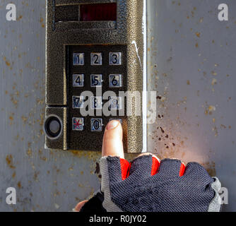 Completion of dialing code on the intercom by pressing the call button Stock Photo
