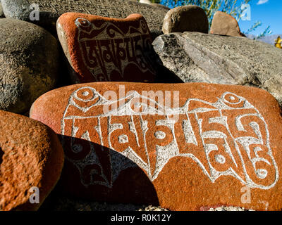 Mani-stones with the carved 'Om Mani Padme Hum', the mantra of Avalokiteswara, the Buddha of Compassion Stock Photo