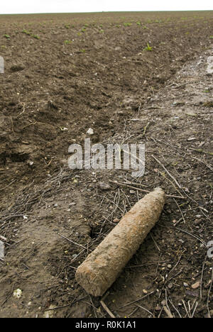 A farmer plowed up this World War One artillery shell while plowing and laid it on the side of the field for disposal, near Vaux-sur-Somme, France. Stock Photo