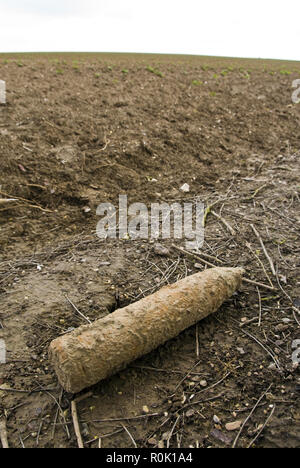 A farmer plowed up this World War One artillery shell while plowing and laid it on the side of the field for disposal, near Vaux-sur-Somme, France. Stock Photo