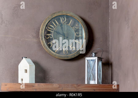 Room interior with wooden toy house, lanterns and clock on wall background.wall clock, lantern, decor, house. Interior details.Copy space Stock Photo