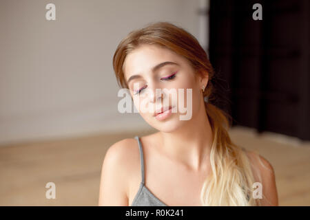 Thoughtful young woman wearing sports bra while listening music against  buildings in city Stock Photo - Alamy