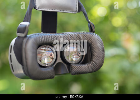 Side view of VR Glasses or Virtual Reality Headset use with smartphone. VR is an immersive experience in which your head movements are tracked in 3d Stock Photo