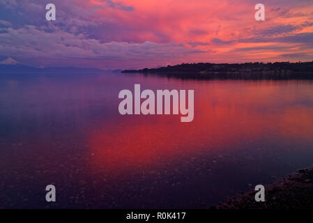 Frame of a time lapse - Sunset in Frutillar overlooking Lake Llanquihue and the Osorno and Calbuco volcanoes Stock Photo