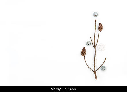 Christmas tree made of  branches and silver decorations. Christmas, winter, new year concept. Flat lay, top view, square. Stock Photo