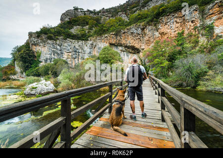 Man enjoying nature with dog in Krka National Park,Croatia. Stock Photo