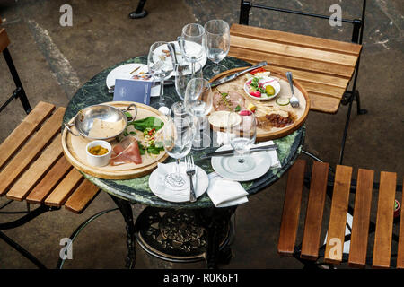 London England,UK,Covent Garden,market,shopping dining entertainment,central hall building,table,finished meal,dirty plates,empty glasses,silverware,l Stock Photo