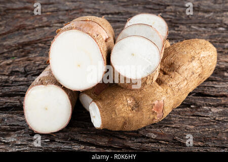 Raw yucca starch on the wooden table - Manihot esculenta. Stock Photo