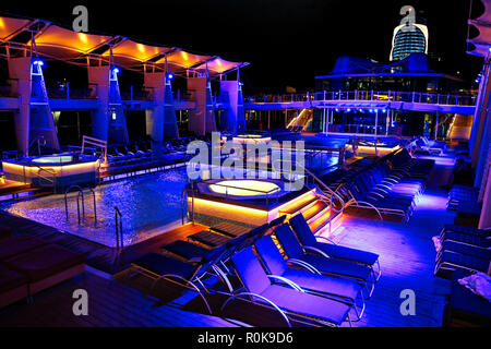 Nassau, Bahamas-2 October, 2017: Cruise ship swimming pool at night on the top deck with scenic views Stock Photo