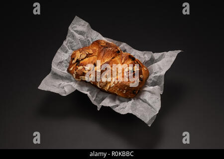 Freshly baked Easter bread with chocolate and almonds isolated on black background Stock Photo
