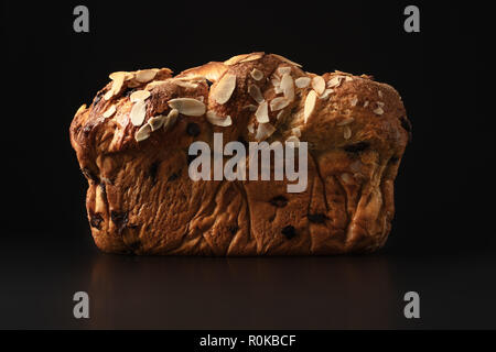 Easter bread with chocolate and almonds isolated on black background. Stock Photo