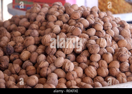 Heap whole walnuts for sale in a nuts and dried fruits shop. Stock Photo