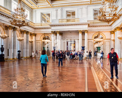 19 September 2018: St Petersburg, Russia - Visitors in St George's Hall, or the Great Throne Room, in the Winter Palace, part of the Hermitage Museum. Stock Photo