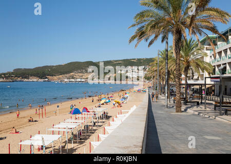 View along promenade and beach on sunny summer morning, Sesimbra, Setubal district, Lisbon region, Portugal Stock Photo