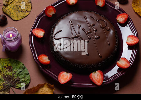 a delicious Viennese chocolate sacher cake with strawberries on plate Stock Photo