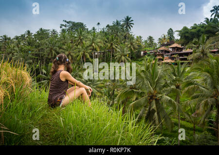Beautiful woman looking at beautiful tegallalang rice terrace in Bali, Indonesia. Stock Photo