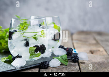 Blackberry mojito and ingredients on rustic background Stock Photo