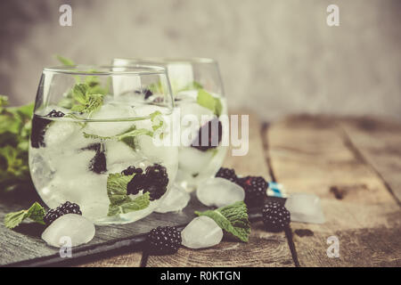 Blackberry mojito and ingredients on rustic background Stock Photo