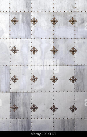 Gothic metal wall, detail of an old steel door decorated, decoration and protection Stock Photo