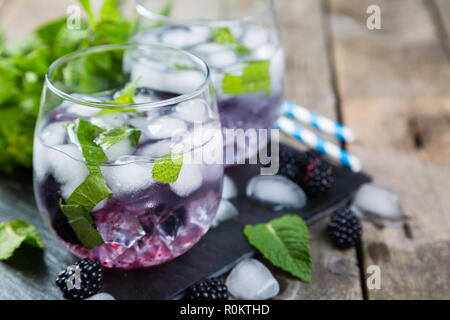 Blackberry mojito and ingredients on rustic background Stock Photo