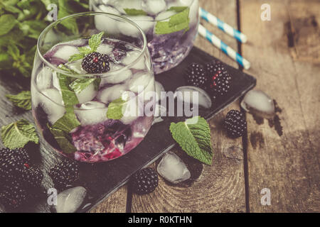 Blackberry mojito and ingredients on rustic background Stock Photo
