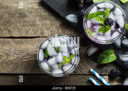 Blackberry mojito and ingredients on rustic background Stock Photo