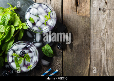 Blackberry mojito and ingredients on rustic background Stock Photo